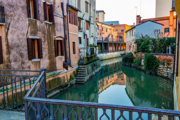 Fototapeta na wymiar View between the houses of a canal in Mestre, Veneto - Italy