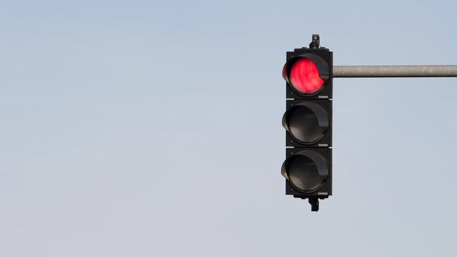 Traffic light semaphore changing colors from green to red