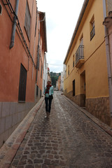 Woman on the narrow street of Xativa, Spain