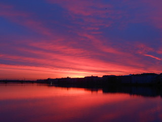 Fototapeta na wymiar Bright colorful sunrise or sunset in Saint-Petersburg. Landscape. Neva river and sea