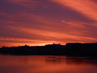 Obraz premium Bright colorful sunrise or sunset in Saint-Petersburg. Landscape. Neva river and sea