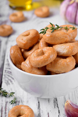 Italian snack Tarallini with herbs and garlic in a white ceramic bowl