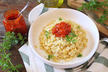 Pearl barley with tomato sauce and grated parmesan cheese