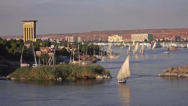 Beautiful landscape with felucca boats on Nile river in Aswan at sunset, Egypt, 4k