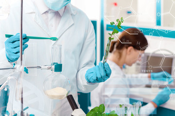 Man is working with laboratory supplies, tools, glass flasks, test tubes. Scientists are making...