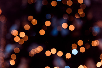 Yellow and blue bokeh balls background. Golden holiday glowing backdrop. Defocused Background With Blinking Stars.