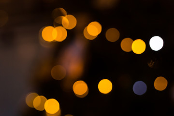 Yellow bokeh balls background. Golden holiday glowing backdrop. Defocused Background With Blinking Stars.