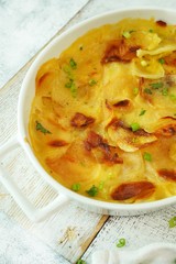 Homemade scalloped potatoes/ Potato gratin close up, selective focus