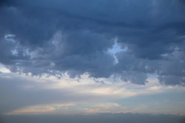Dark clouds on evening sky, cumulus clouds high, beautiful aerial cloudscape view from above