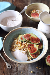 Oatmeal, yogurt, ripe figs, walnutsin bowl and milk