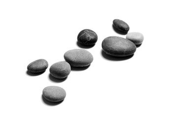 Smooth stones isolated on white background. Heap of gray and black sea pebbles. Spa objects