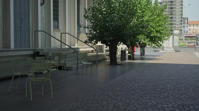 Gimbal pan shot left to right of contemporary business building outdoors in summer in Italy, prada foundation. Italian business building outdoors in summer time
