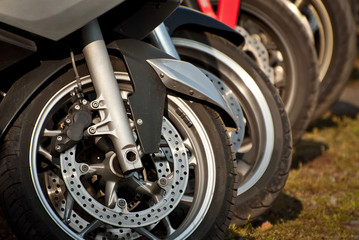 Obraz premium Motorcycle wheel closeup. Motorcycle metal parts. Biker meeting in the city.