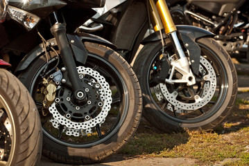Fototapeta premium Motorcycle wheel closeup. Motorcycle metal parts. Biker meeting in the city.