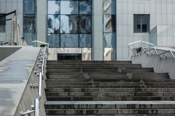 Entrance to modern office building. The front door to scyscaper. Stairs and glass door of commercial business block. Building reflecting in the glass
