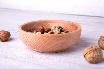 wood serving spoon with Assortment nuts on wooden table. Close-up.