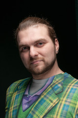 Obraz premium portrait of good-looking man with beard and hipster hair style in green fashionable blazer isolated on black