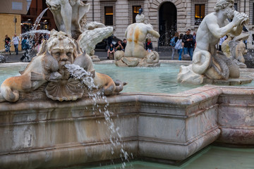 Mythical statues spewing water  on fountain in Rome, Italy