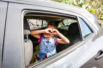 girl in the car looking throw window