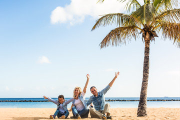 happy family hands up on the beach