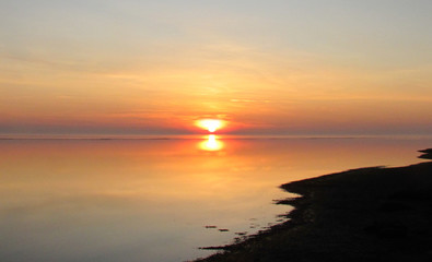 Winter evening on the beach by the sea 