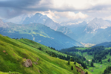 Fototapeta na wymiar View of mountains and Canazei village from Sella pass, Dolomites Alps, Italy, Europe