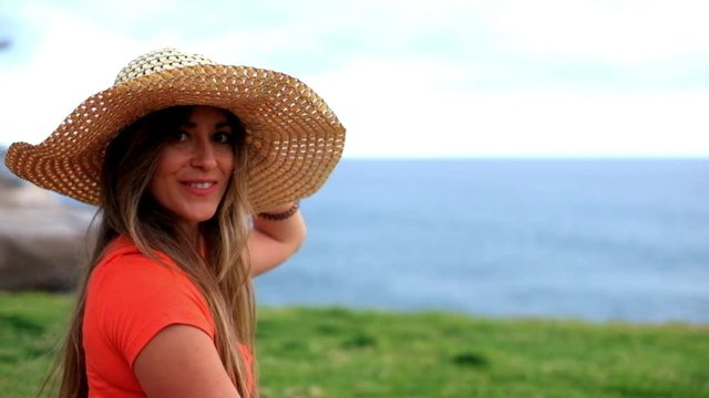 Beautiful young caucasian woman enjoying the outdoor leisure activity alone - girl have fun in the park - people with nature around - attractive trendy female with red shirt and white pants