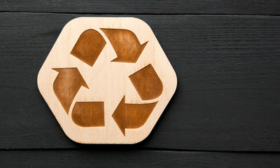 The wooden recycling icon on the table