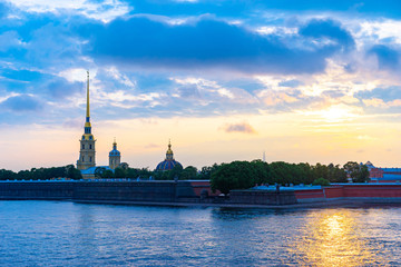 Evening Petersburg. Rivers Of St. Petersburg. Summer trip to Russia. The sun is reflected in the Neva. Peter and Paul fortress on the background of water and sky. Clouds over St. Petersburg.