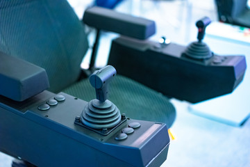 Work chair with remote control. Armchair with joysticks. Chair for equipment control. Joysticks integrated in the armrests of the operator's seat.