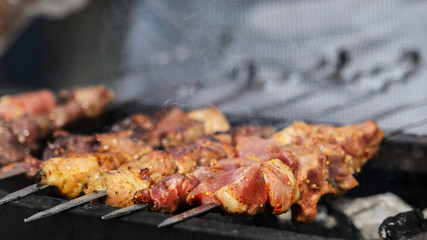 Pork skewers on the grill in the fresh air