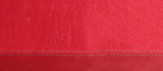 red leather background with red stitches