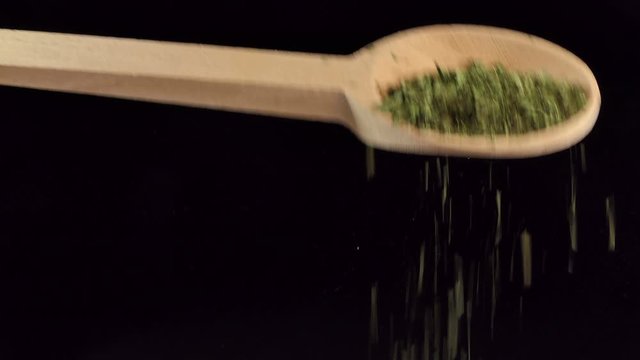 One spoon of corriander leaves. Spices and food ingredients.
