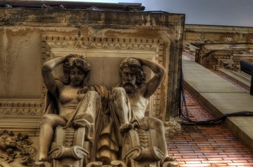 Atlas and Caryatid supporting a balcony in Seville, Andalusia, Spain. Detail.