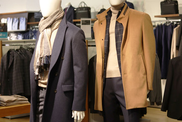 Men's clothing in the store. Men's fashion. Mannequin in the center of the hall