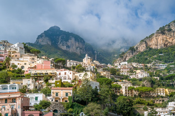 Fototapeta na wymiar Amalfi coast landscapes - Positano village. Traditional colorful houses and mountain view. Italy.