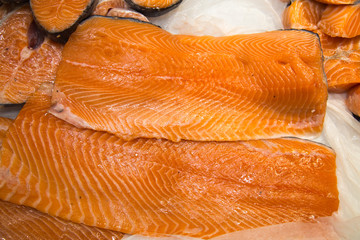 Salmon fillet, chilled in the background of white ice. Seafood, fish, useful products.