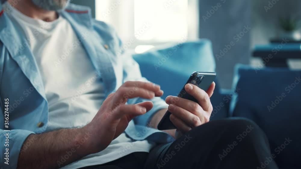 Wall mural close up view of male hands uses phone texting message, browsing surfinf internet tapping scrolling 