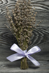 A bunch of lavender tied with a ribbon. Against the background of brushed boards.