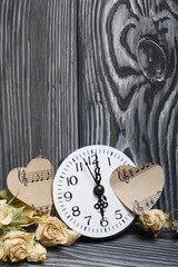 Dried roses and watches on a background of brushed boards.