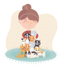 smiling old woman hugging many cats