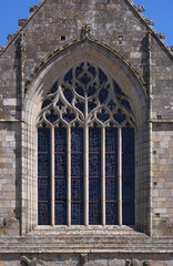 Pointed gothic window with flamboyant tracery at Saint Sauveur Basilica in Dinan city, Brittany in France