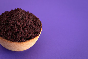 Bowl Full of Organic Acai Powder a Superfood on a Bright Purple Background