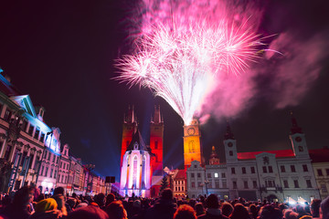 Crowd of people watching New Year fireworks in historic city center of Hradec Kralove, Czech Republic