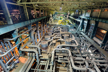 Coal power plant interior with pipes. Heat exchanger and energy equipments