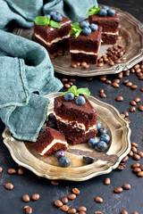 Delicious chocolate cakes on plate on dark table