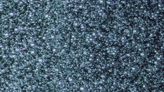 Water light blue structure. Bubbles of oxygen under liquid. Macro abstraction.