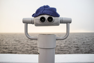 Tower viewer in a hat, looks like a smiling face, against the background of sea and the horizon, in...