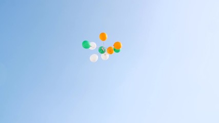 Beautiful tricolor balloons are flying away in the sky - Independence/Republic day  India. Woman hands releasing a bunch of orange  white  and green balloons in the sky during 26 January/15 August ... - Powered by Adobe