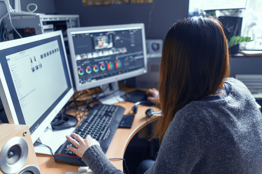 The Brunette Is Carefully At The Monitor Of Her Computer And Working In A Video Processing Program